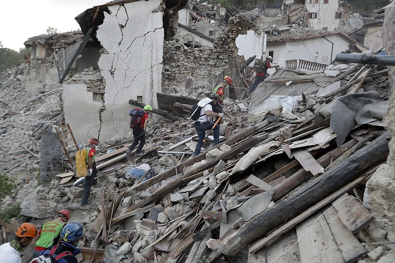 
              Rescuers search through debris following an earthquake in Pescara Del Tronto, Italy, Wednesday, Aug. 24, 2016. The magnitude 6 quake struck at 3:36 a.m. (0136 GMT) and was felt across a broad swath of central Italy, including Rome where residents of the capital felt a long swaying followed by aftershocks.  (AP Photo/Andrew Medichini)
            