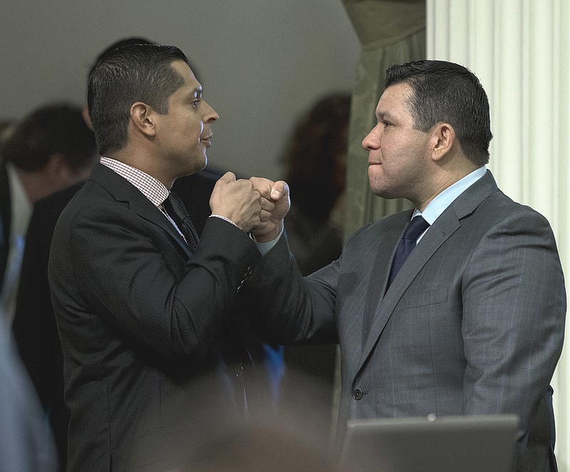 
              Assemblyman Eduardo Garcia, D-Coachella, right, receives congratulations from Assemblyman Miguel Santiago, D-Los Angeles, after his measure to give lawmakers more oversight over the state's efforts to combat global warming was approved by the Assembly Wednesday, Aug. 24, 2016, in Sacramento, Calif. Garcia's bill, AB197, would add two legislators as non-voting members of the Air Resources Board, which enforces California's law targeting green-house gas reductions. (AP Photo/Rich Pedroncelli)
            