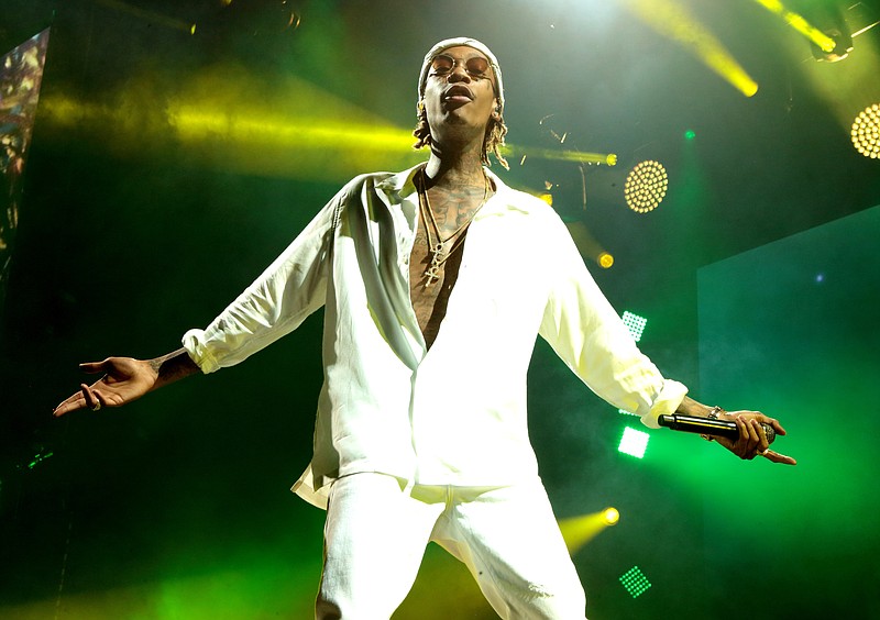
              FILE - In this Aug. 5, 2016 file photo, Wiz Khalifa performs during his "The High Road Tour" at the BB&T Pavilion in Camden, N.J. A lawyer representing 17 people injured when a railing collapsed at the Aug. 5, concert is suing the performers and the venue's owner. (Photo by Owen Sweeney/Invision/AP, File)
            