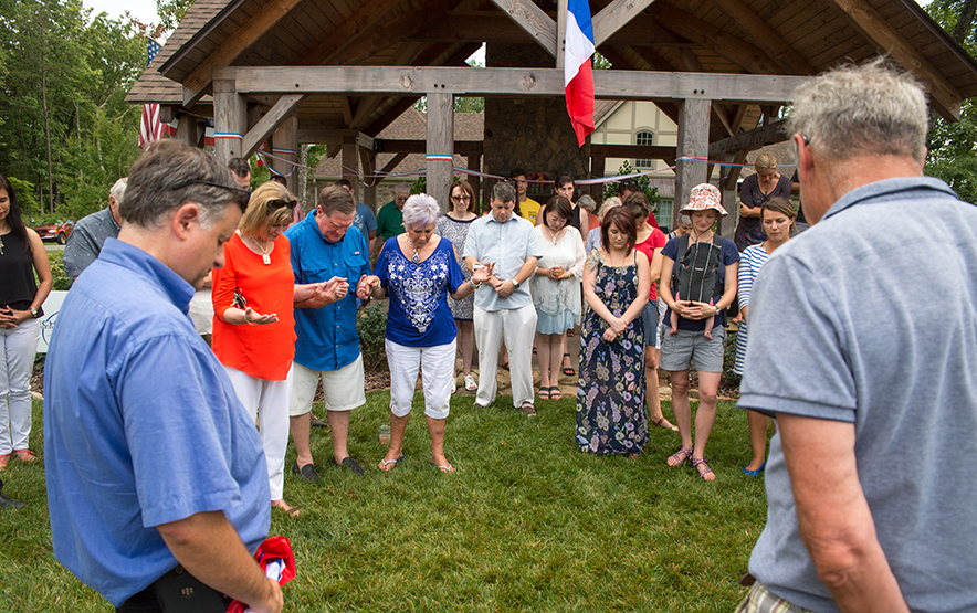 Frank Brock says a prayer followed by a moment of silence for the attacks in Nice, Italy.
