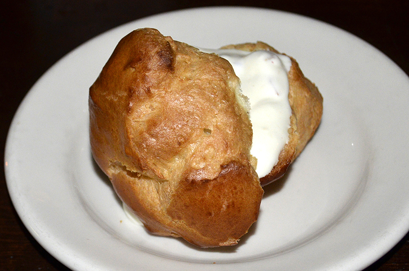 The night's dessert is a profiterol, or cream puff, stuffed with peach and mascarpone cheese.