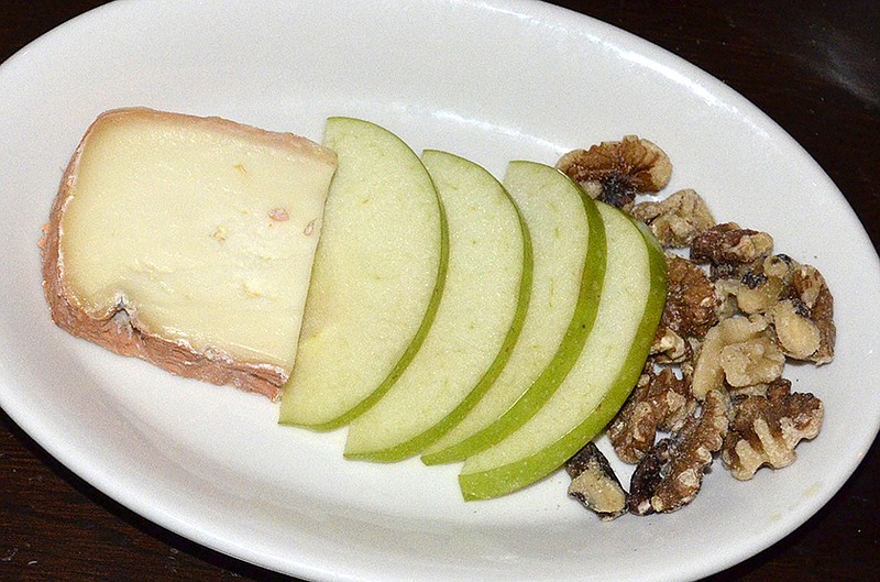 The antipasti course offers taleggio cheese, apples and walnuts.