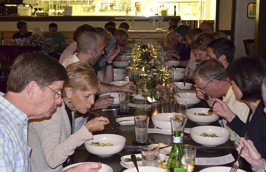 Diners gather at a communal table for one of Hummingbird Pastaria's family-style Tavolata dinners.