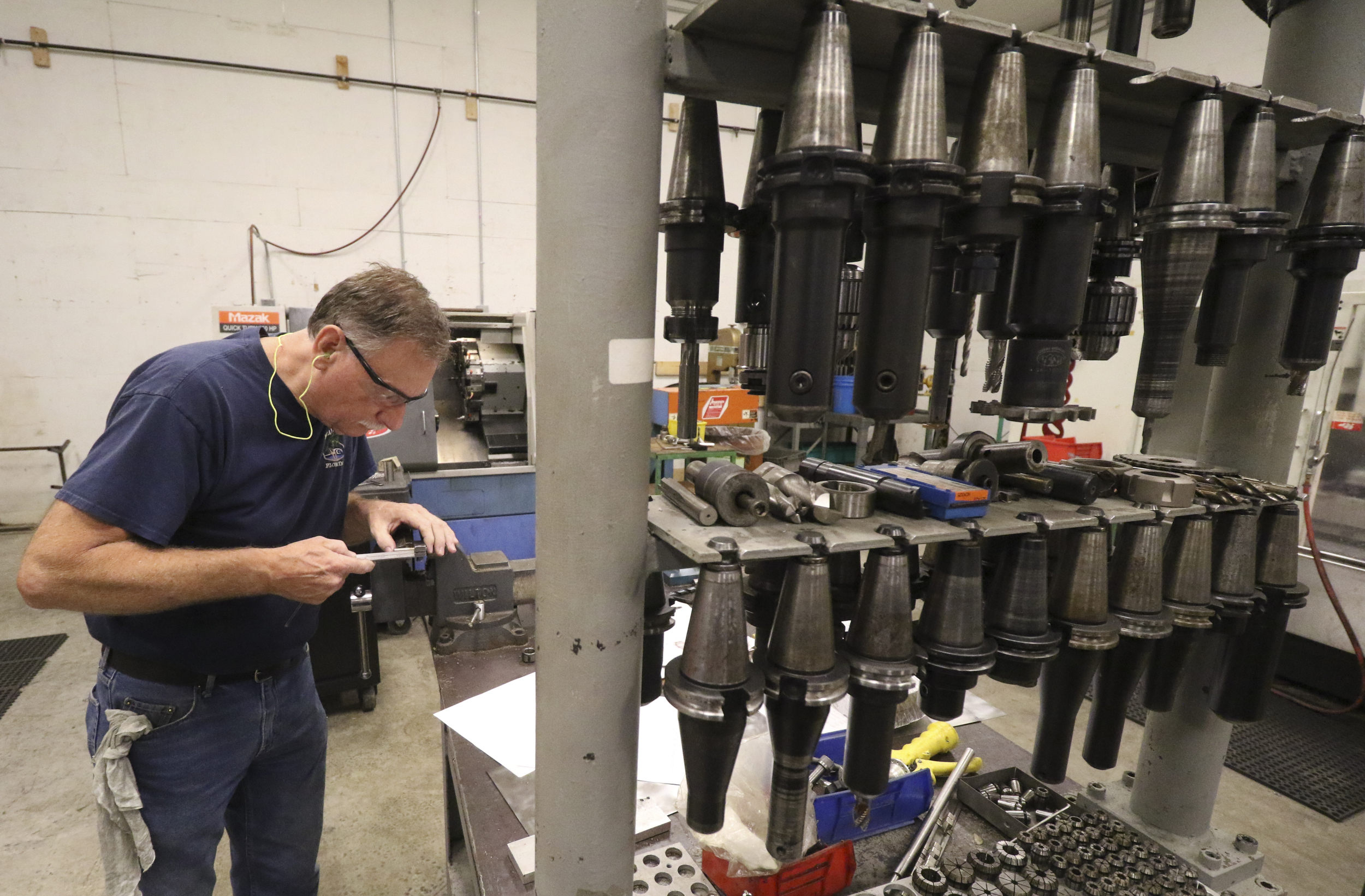 Staff Photo by Dan Henry / The Chattanooga Times Free Press- 8/18/16. Tony Gossett works on mitering a head tube while at American Bicycle Group's new Amnicola Highway location on Thursday, August 18, 2016.