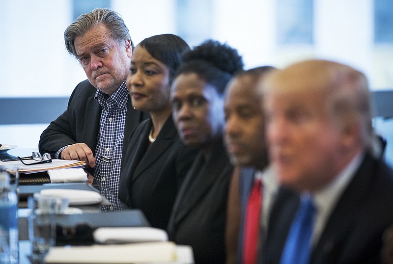 Trump's new campaign chief Stephen Bannon, left, listens as Donald Trump, right, speaks during a meeting with primarily minority leaders from the RNC's Republican Leadership Initiative at Trump Tower in New York on Thursday. (Damon Winter/The New York Times)