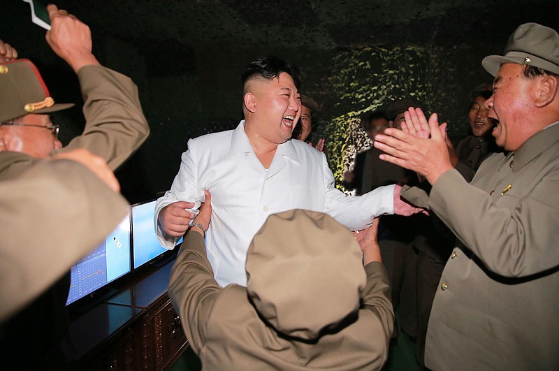 
              In this undated photo distributed on Thursday, Aug. 25, 2016, by the North Korean government, North Korean leader Kim Jong Un, center, visits the site of a submarine-launched missile test at an undisclosed location in North Korea. Independent journalists were not given access to cover the event depicted in this image distributed by the Korean Central News Agency via Korea News Service. Kim said Thursday, Aug. 25, 2016, that his country had achieved the "success of all successes" in launching a missile from a submarine, saying it effectively gave the country a fully equipped nuclear attack capability and put the U.S. mainland within striking distance. Associated Press Photo Editors have detected evidence of photo manipulation on Kim Jong Un's face in this image. (Korean Central News Agency/Korea News Service via AP)
            