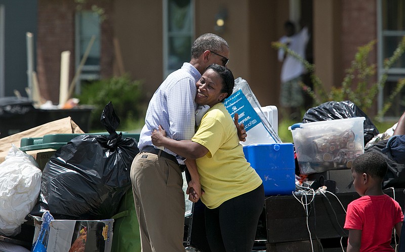 
              FILE - In this Tuesday, Aug. 23, 2016, file photo, President Barack Obama hugs Marlene Sanders as he visits with with residents of Castle Place, a flood-damaged area of Baton Rouge, La. (Ted Jackson/NOLA.com The Times-Picayune via AP, File)
            