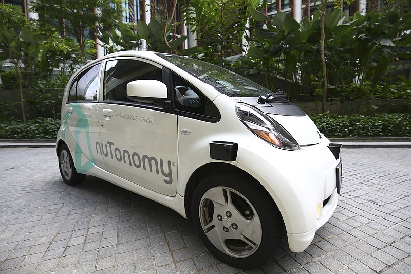 
              An autonomous vehicle is parked for its test drive in Singapore Wednesday, Aug. 24, 2016. The world’s first self-driving taxis, operated by nuTonomy, an autonomous vehicle software startup, will be picking up passengers in Singapore starting Thursday, Aug. 25. The service will start small - six cars now, growing to a dozen by the end of the year. The ultimate goal, say nuTonomy officials, is to have a fully self-driving taxi fleet in Singapore by 2018, which will help sharply cut the number of cars on Singapore’s congested roads. (AP Photo/Yong Teck Lim)
            