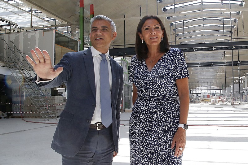 
              London mayor Sadiq Khan, left, poses with Paris mayor Anne Hidalgo at the Halle Freyssinet, a future digital business incubator, in Paris, Thursday, Aug. 25 2016. Khan is in France to mark the 72th anniversary of the Liberation of Paris. (AP Photo/Michel Euler)
            
