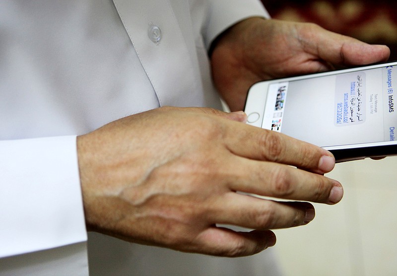 
              Human rights activist Ahmed Mansoor shows Associated Press journalists a screenshot of a spoof text message he received in Ajman, United Arab Emirates, on Thursday, Aug. 25, 2016. Mansoor was recently targeted by spyware that can hack into Apple's iPhone handset. The company said Thursday it was updated its security. The text message reads: "New secrets on the torture of Emirati citizens in jail." (AP Photo/Jon Gambrell)
            