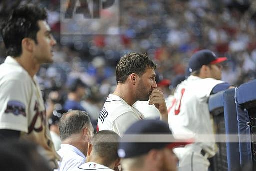 Atlanta Braves players including Jeff Francoeur, center, watch the final moments of a baseball game against the Washington Nationals during the ninth inning, Saturday, Aug. 20, 2016, in Atlanta. Washington won 11-9. (AP Photo/John Amis)