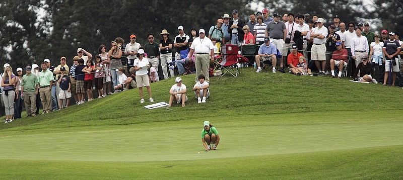 In this Oct. 4, 2009 file photo, Michelle Wie lines up her putt on the 13th green during the final round of the Navistar LPGA Classic golf tournament at the Robert Trent Jones Golf Trail at Capitol Hill in Prattville. (AP photo/Jamie Martin, File)