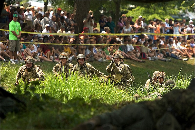 A crowd watches a WWII re-enactment at the Secret City Festival.