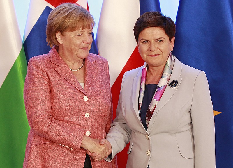 
              German Chancellor Angela Merkel,left, is greeted by Poland's Prime Minister Beata Szydlo in Warsaw, Poland, Friday, Aug. 26, 2016., as she arrives for talks with four central European leaders about the shape of the European Union after Britain leaves and about migrants, ahead of an EU summit planned next month.(AP Photo/Czarek Sokolowski)
            