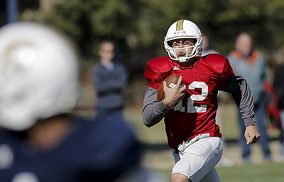 UTC quarterback Tyler Roberson keeps during the Mocs' first spring football scrimmage Saturday, March 28, 2015, at Scrappy Moore Field in Chattanooga, Tenn.