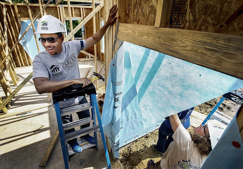
              Dwayne Spencer, President & CEO of Habitat for Humanity of Greater Memphis, works with hundreds of volunteers in the Bearwater neighborhood north of Uptown in Memphis, to build 19 new homes during the Jimmy & Rosalyn Carter Work Project, Thursday, Aug. 25, 2016. (Mark Weber/The Commercial Appeal via AP)
            