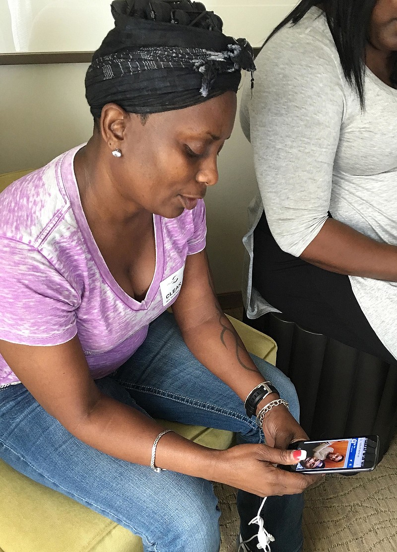 
              FILE - In this Sunday, June, 12, 2016 file photo, Wilhemina Justice looks at a photo of her son, Eddie Justice, who was killed in the Pulse nightclub mass shooting, as she speaks to a reporter in Orlando, Fla. In the wake of his death, a friend of Eddie and another man set up a GoFundMe charity page in his memory, saying the money would pay for his funeral and victim counseling. But Justice's mother said no one consulted her about the appeal in her son's name or made arrangements to give her proceeds. "To me, it's fraud," she said. (AP Photo/Tamara Lush)
            