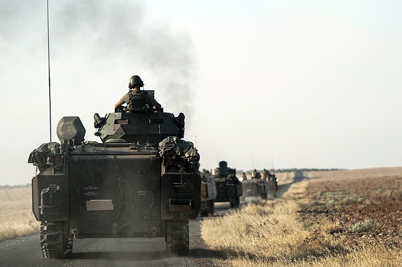 
              Turkish troops head to the Syrian border, in Karkamis, Turkey, Saturday, Aug. 27, 2016. Turkey on Wednesday sent tanks across the border to help Syrian rebels retake the key Islamic State-held town of Jarablus and to contain the expansion of Syria's Kurds in an area bordering Turkey .(AP Photo/Halit Onur Sandal)
            