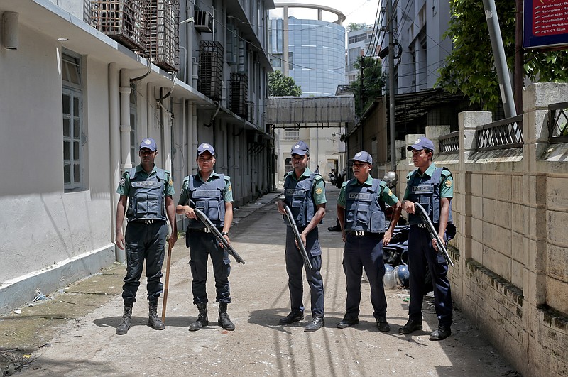 
              FILE - In this Wednesday, July 27, 2016, file photo, Bangladeshi policemen stand guard outside a morgue at the Dhaka Medical College Hospital during the autopsy on the bodies of suspected Islamic militants who were killed in Dhaka, Bangladesh. Police in Bangladesh, on Saturday, say they have killed three suspected militants, including one of two alleged masterminds of a major attack on a cafe last month that left 20 people dead. Top counterterrorism official Monirul Islam said police raided a two-story house in Narayanganj district near Dhaka and killed the suspects early Saturday. (AP Photo, File)
            