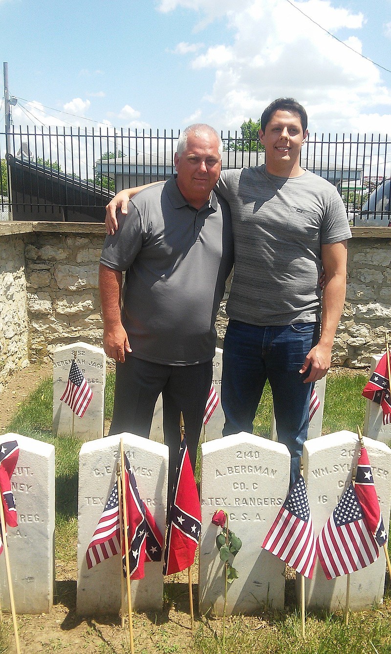 
              In this May 30, 2016 photo, Gregory Beckman and his son, Marcus, visit the grave site of their relative Augustus Beckmann at Camp Chase Confederate Cemetery on Memorial Day weekend. The name and information on the stone is incorrect. Due to Beckman's efforts in tracking down his family history and noting that the stone is wrong, a national cemetery association will fix it. (Ted Decker/The Columbus Dispatch via AP)
            