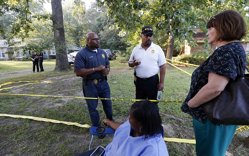 
              Durant Police Chief John Haynes, left, and assistant Police Chief James Lee reassure Lexington Medical Clinic employees Lisa Dew, right, and Viola Turner, seated, that the Mississippi Bureau of Investigation was giving the home of two slain Catholic nuns who worked as nurses at the clinic a through crime scene investigation, Thursday, Aug. 25, 2016, in Durant. The clinic office manager and a Durant police officer discovered their bodies inside the house after both nuns did not report for work. Authorities said there were signs of a break-in and their vehicle was missing. (AP Photo/Rogelio V. Solis)
            