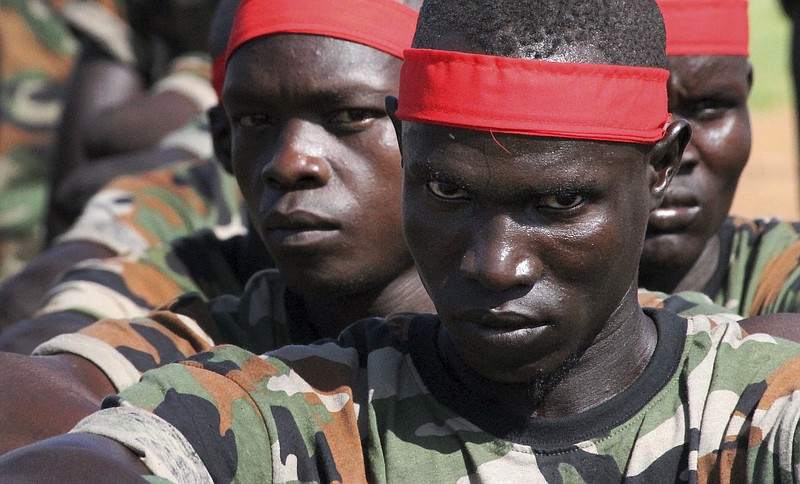 
              In this photo taken Monday, May 16, 2016, a group of government soldiers wait in line during a military parade celebrating the national army in Juba, South Sudan. When South Sudan's president signed a peace deal a year ago to end the country's civil war he added 16 reservations to the agreement, which have now become a map of how it has unraveled. (AP Photo/Justin Lynch)
            