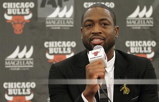 FILE- In this July 29, 2016, file photo, Chicago Bulls player Dwyane Wade speaks during a news conference in Chicago. A family spokesman says a cousin of Wade's was fatally shot Friday, Aug. 25, while pushing a baby in a stroller on the city's South Side. Wade posted on Twitter: "My cousin was killed today in Chicago. Another act of senseless gun violence. 4 kids lost their mom for NO REASON. Unreal." (AP Photo/Tae-Gyun Kim, File)