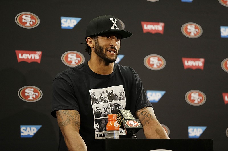 San Francisco 49ers quarterback Colin Kaepernick answers questions after Friday's preseason game against the Green Bay Packers.