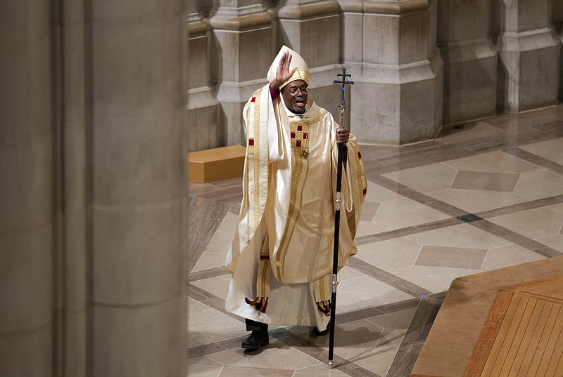 ADVANCE FOR USE MONDAY, AUG. 29, 2016 AND THEREAFTER-FILE - In this Sunday, Nov. 1, 2015 file photo, Episcopal Church Presiding Bishop Michael Curry waves to the crowd after Mass at the Washington National Cathedral in Washington. Curry, the church's first black leader, was elected in June 2015 to succeed Presiding Bishop Katharine Jefferts Schori, the first woman leader of the church. (AP Photo/Jose Luis Magana)