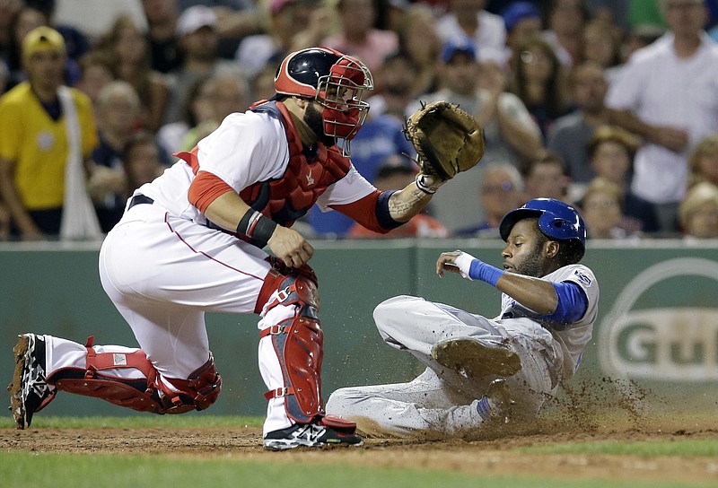 
              Kansas City Royals' Lorenzo Cain, right, slides safely at home as Boston Red Sox's Sandy Leon, left, waits for the ball in the sixth inning of a baseball game, Sunday, Aug. 28, 2016, in Boston. (AP Photo/Steven Senne)
            