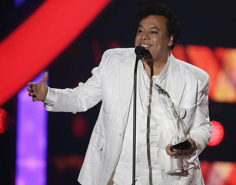 
              FILE- In this April 28, 2016, file photo, singer Juan Gabriel receives the Star Award at the Latin Billboard Awards, in Coral Gables, Fla. Representatives of Juan Gabriel have reported Sunday, Aug. 28, 2016, that he has died. Gabriel was Mexico's leading singer-songwriter and top-selling artist with sales of more than 100 million albums. The statement says he died Sunday, but did not say where. (AP Photo/Wilfredo Lee,File)
            