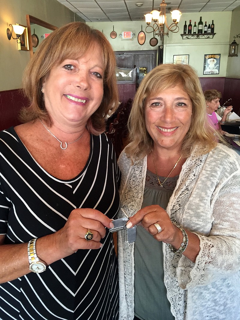 
              In this photo taken Monday, Aug. 22, 2016 and provided by Audrey Berk, Berk, left, of Queens, N.Y., and Laurie Lubin of Bellmore, N.Y., hold the World War II dog tags of Berk's father, Irving Isaacs in Bellmore, N.Y. Lubin found the tags on a New York City beach in the summer of 1966 and spent the next 50 years trying to return them. Lubin finally tracked down Isaacs' daughter with the help of The Associated Press and gave her the dog tags at a Bellmore restaurant on Aug. 22. (Audrey Berk/Laurie Lubin/Clifford Kaplan via AP)
            