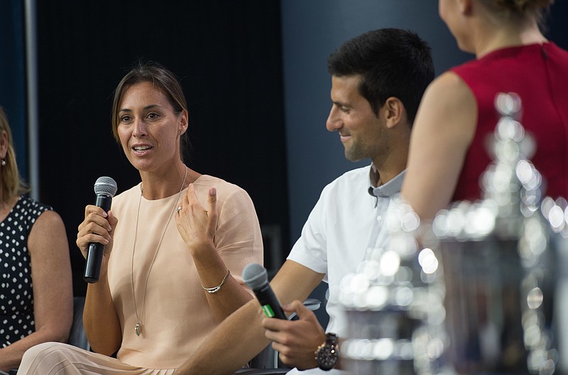 
              Reigning U.S. Open tennis women's singles champion Flavia Pennetta, of Italy, speaks as men's singles champion Novak Djokovic looks on during a media availability at the Billie Jean King National Tennis Center, Friday, Aug. 26, 2016,  in New York. (AP Photo/Bryan R. Smith)
            