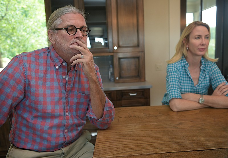 
              ADVANCE FOR WEEKEND EDITIONS - In this Aug. 17, 2016, photo, Stephen and Dorene Pearson talk about their real estate experience, while sitting in their home kitchen in Leiper's Fork, Tenn. The couple said they were scammed by a couple claiming they would buy their $5.2 million estate in Leiper's Fork. (Ricky Rogers/The Tennessean via AP)
            