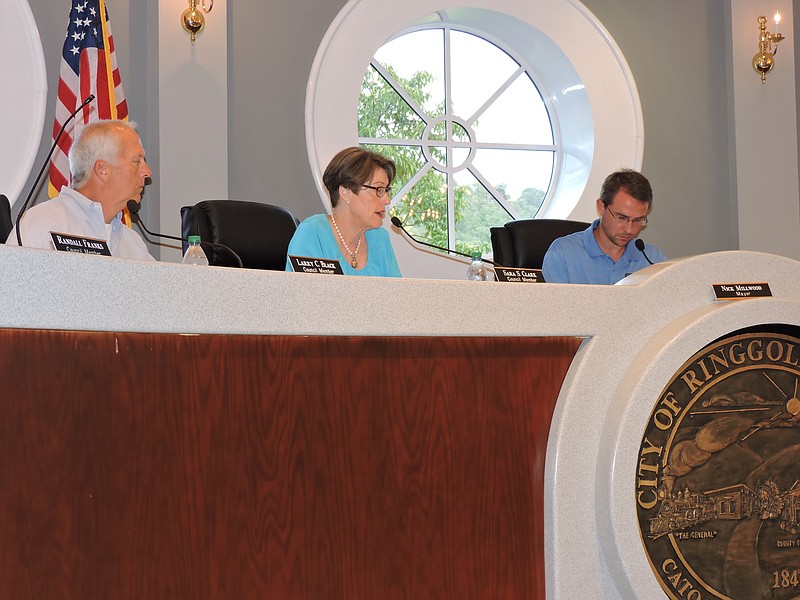 From left are Councilman Larry Black, Councilwoman Sarah Clark and Mayor Nick Millwood discuss city business at a recent Council meeting inside Ringgold City Hall.