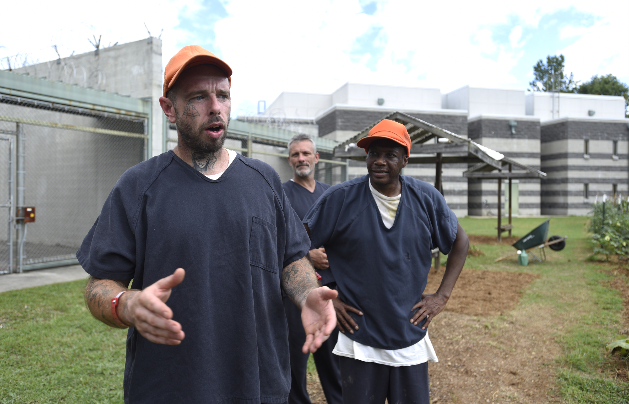 Jason Hughes, from left, Tim Kelly and Leander Johnson discuss the work they put into their garden at the Catoosa County Jail.