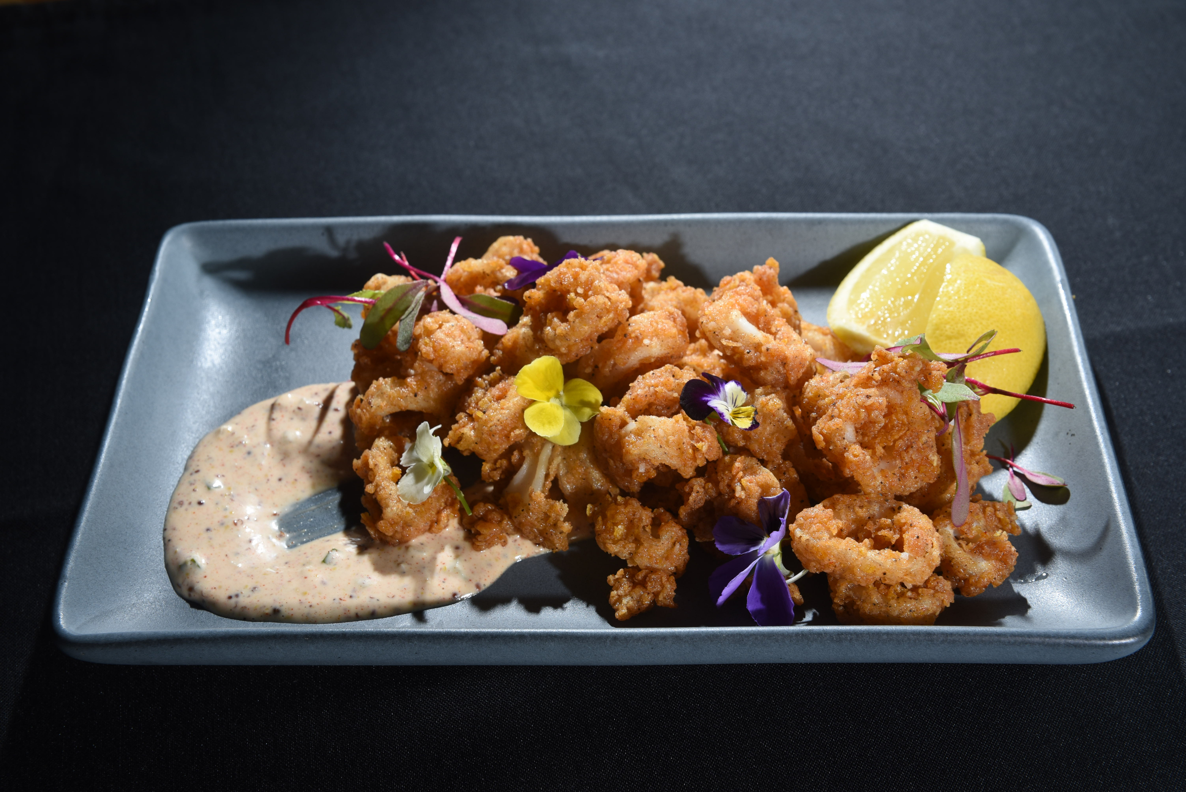 Chef David Wright prepares a Cornflake Calamari dish at the Flying Squirrel.