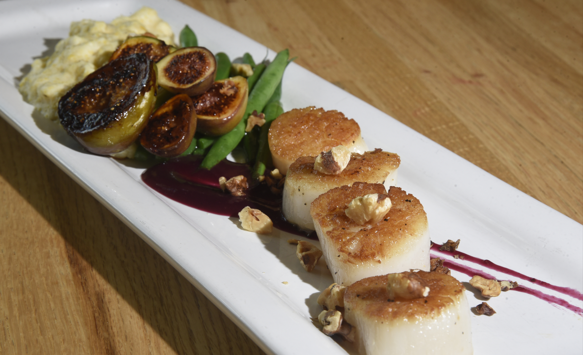 Sustainable Scallops with Creamy Logan Turnpike Polenta, Seared Figs and a Wheeler Farm Grape and Rosemary Glaze from 212 Market.