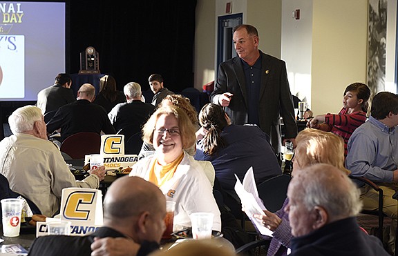 UTC head football coach Russ Huesman chats with attendees at a national signing day event at Finley Stadium on Wednesday, Feb. 3, 2016, in Chattanooga, Tenn. 