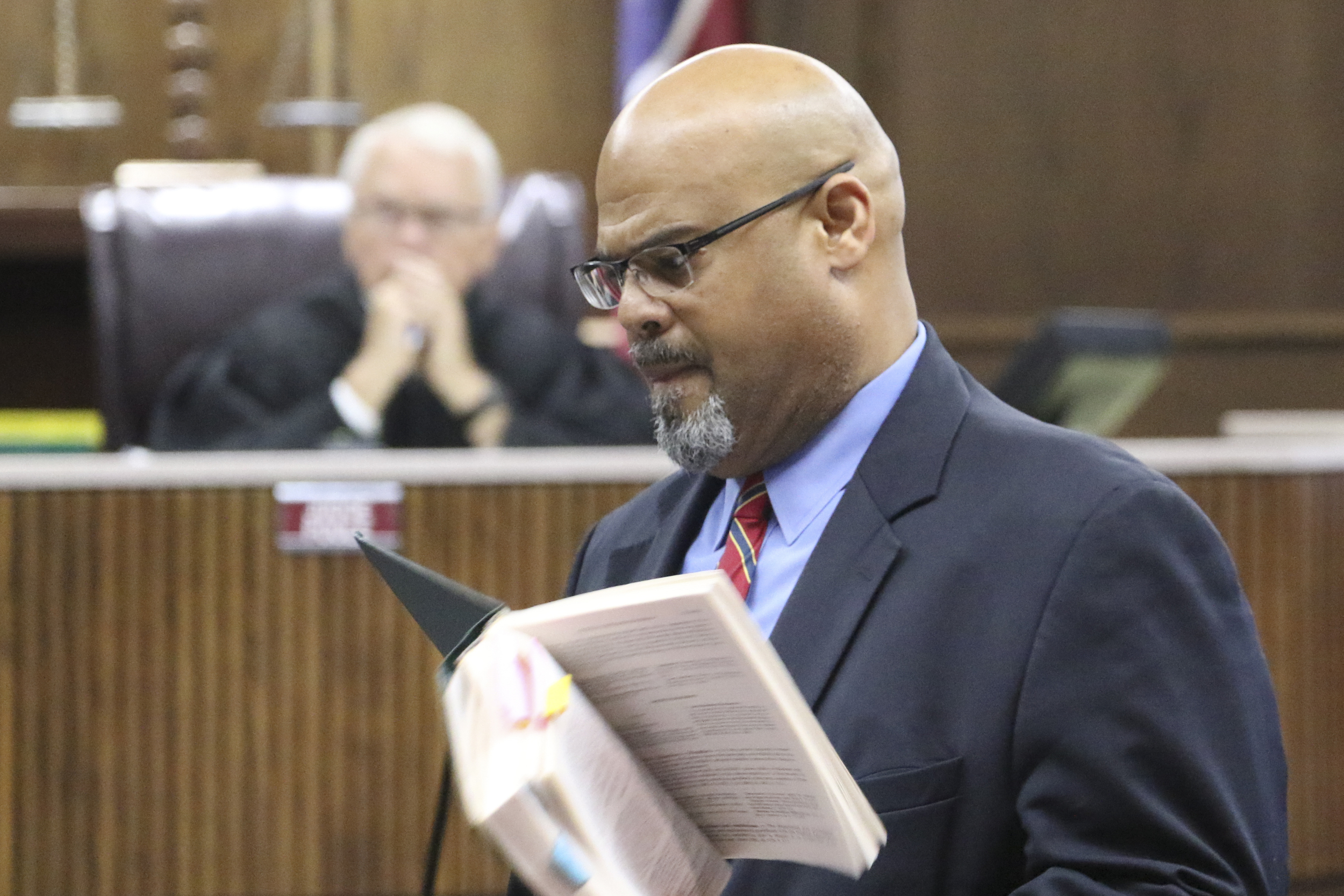 Attorney Curtis Bowe, right, argues that his client, former Ooltewah High School head basketball coach Andre "Tank" Montgomery, should have charges of failure to report child sexual abuse thrown out while appearing before Judge Don Poole on August 31, 2016.