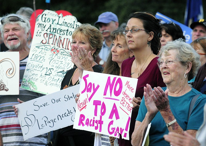 
              People clap during speeches at a rally to protest recent remarks by Maine Gov. Paul LePage in Capital Park in Augusta, Maine, Tuesday, Aug. 30, 2016. Amid political pressure and calls for his resignation, Republican Gov. Paul LePage on Tuesday suggested that he might be considering stepping aside but seemed to reject the idea entirely hours later in a tweet, saying, "The reports of my political demise are greatly exaggerated." (Joe Phelan/The Kennebec Journal via AP)
            