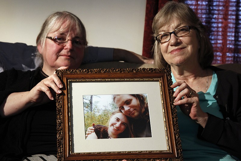 
              FILE- In this June 4, 2014, file photo, mother's Linda Boyle, left and Lyn Coleman hold photo of their married children, Joshua Boyle and Caitlan Coleman, who were kidnapped by the Taliban in late 2012 in Stewartstown, Pa. The State Department is evaluating a video released by the Afghan Taliban showing Joshua Boyle and Caitlan Coleman warning that their Afghan captors will kill them unless the Kabul government ends its executions of Taliban prisoners. State Department spokesman John Kirby said at his daily briefing Tuesday, Aug. 30, 2016, that the video purportedly showing the couple is “being examined for its validity.” (AP Photo/Bill Gorman, File)
            