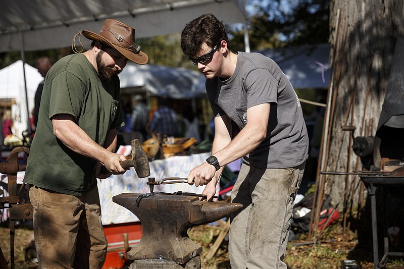 Brian Newton, left, and Culen Pearson demonstrate blacksmithing at last year's Ketner's Mill Country Fair. Experience the festival near Whitwell, Tenn., this year on Oct. 15-16.