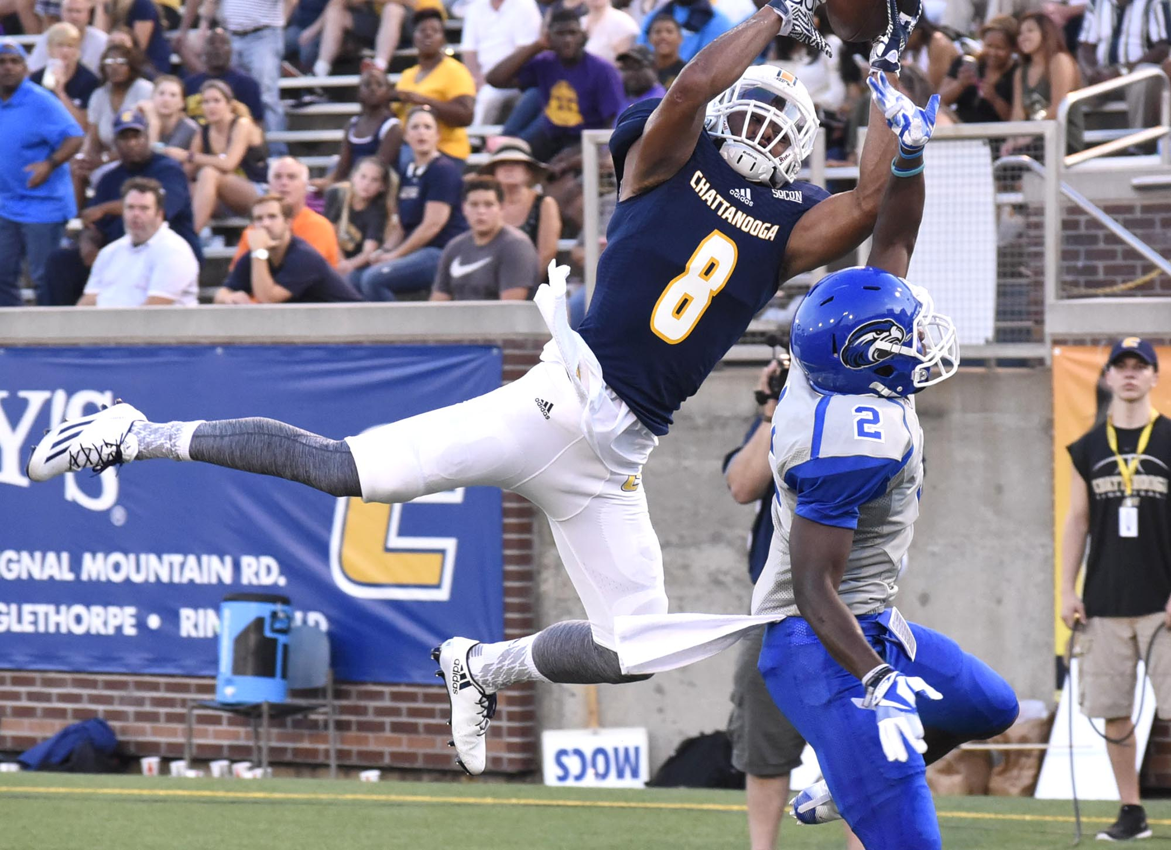 UTC's C.J. Board (8) goes high for a touchdown reception over Shorter's Willy Dorcin (2). The Mocs beat the Hawks 66-0 in the season opener Thursday night at Finley Stadium.