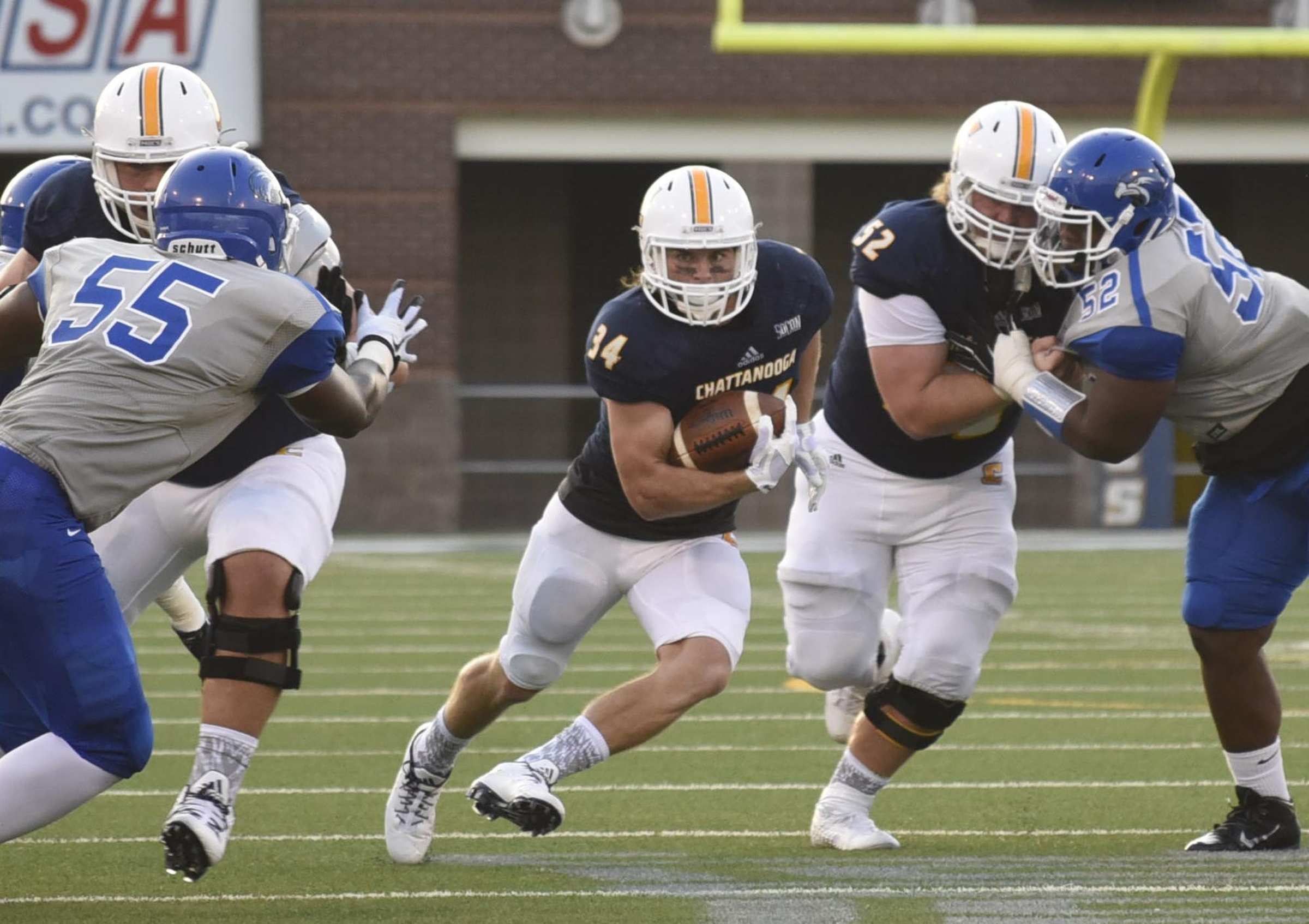 UTC's Derrick Craine (34) cuts through a hole in the Shorter defense. The University of Tennessee/Chattanooga Mocs hosted the Shorter University Hawks in NCAA football action on Sept. 1, 2016.
