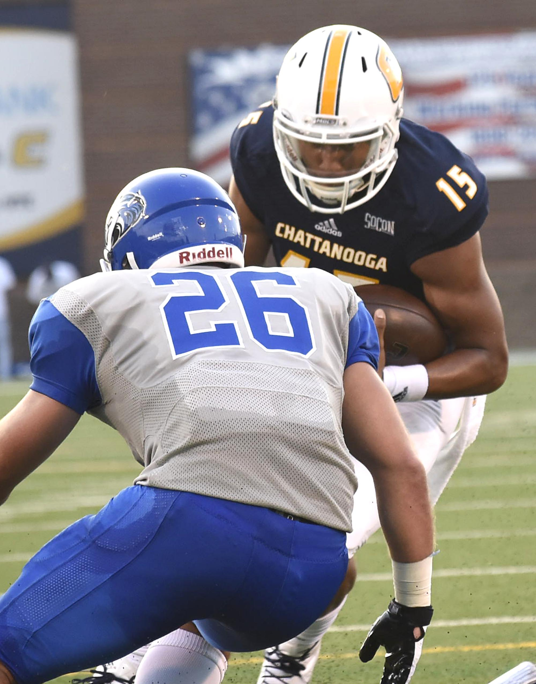 UTC quarterback Alejandro Bennifield (15) lowers his head as he prepares to hit Shorter's John Jarrard (26). The University of Tennessee/Chattanooga Mocs hosted the Shorter University Hawks in NCAA football action on Sept. 1, 2016.
