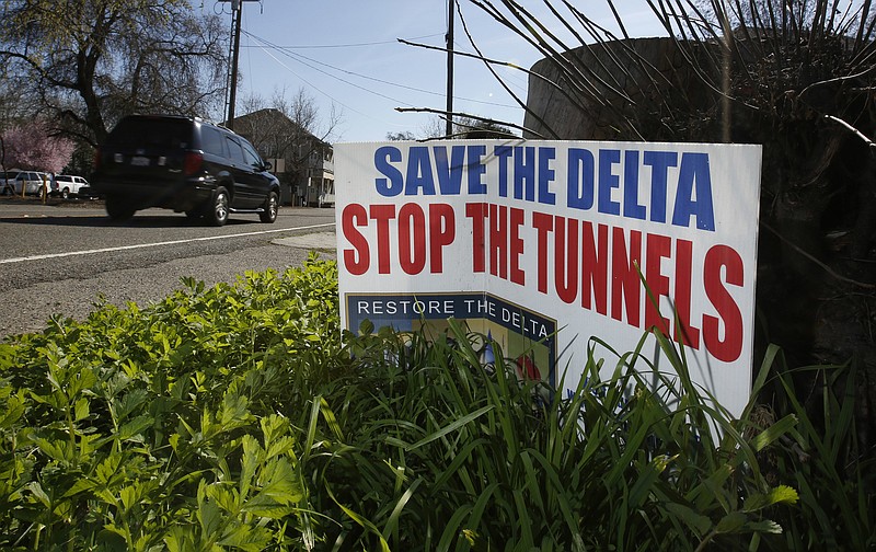
              FILE - In this Feb. 23, 2016, file photo, a sign opposing a proposed tunnel plan to ship water through the Sacramento-San Joaquin Delta to Southern California is displayed near Freeport, Calif. California Gov. Jerry Brown is making it a top priority to defeat a November proposition that would require a statewide vote before issuing bonds to fund mega-projects, such as the governor's proposed high-speed rail and Delta tunnels project. The California Democratic Party and Brown himself are taking part in the campaign to defeat Proposition 53. (AP Photo/Rich Pedroncelli, File)
            
