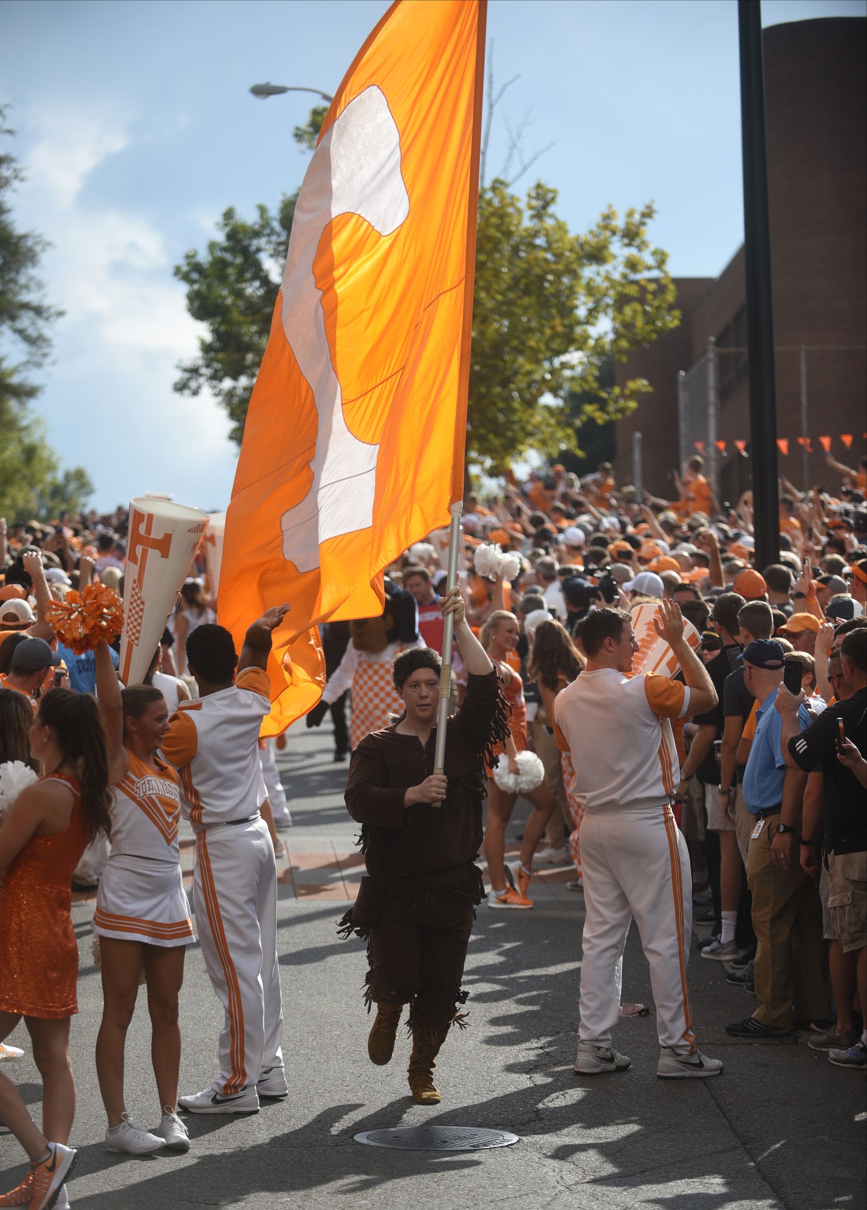 The flag carrier leads the way during the Vol Walk Thursday, Sept. 1, 2016 outside of Neyland Stadium before the game against Appalachian State.