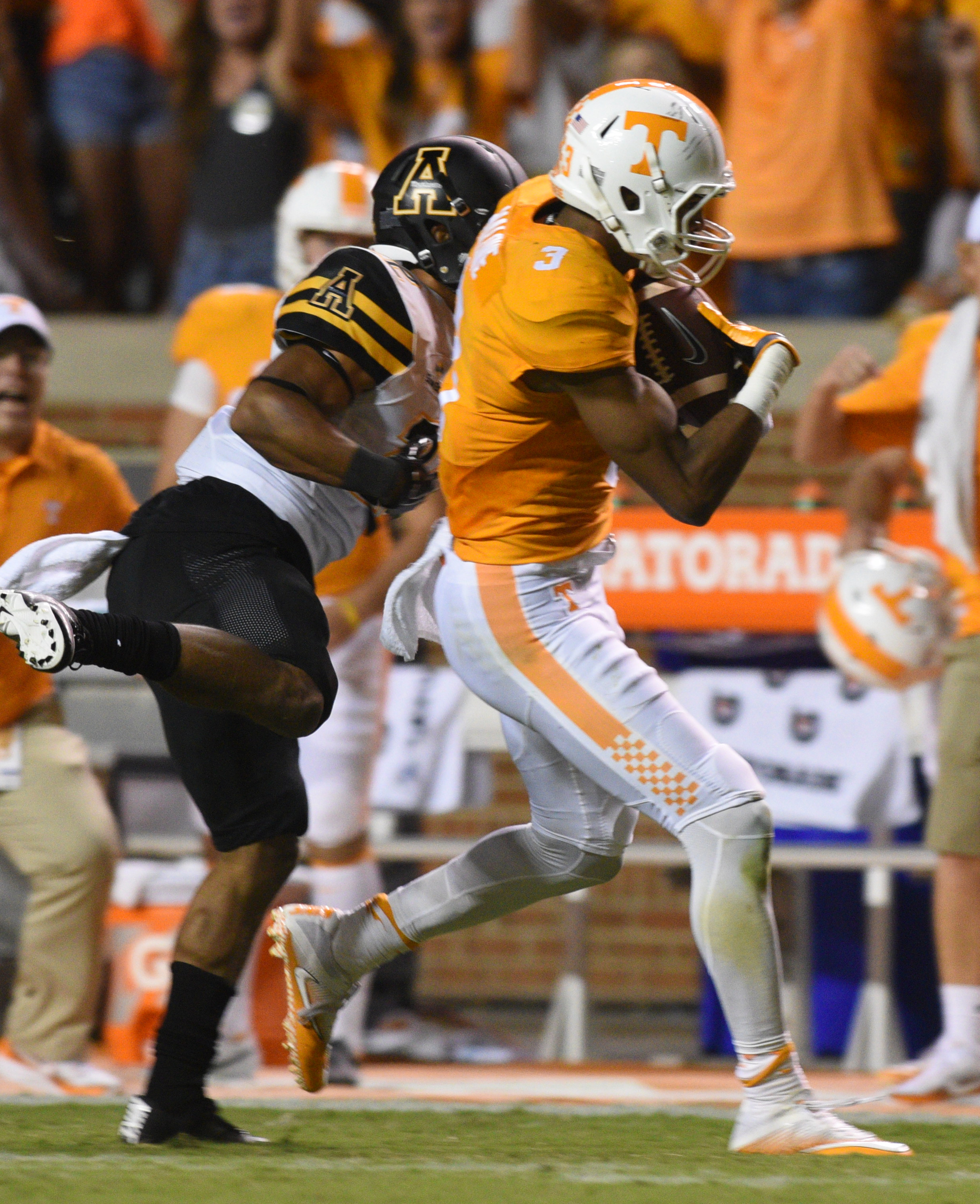 UT's Josh Malone carries in a touchdown pass as Appalachian State's Clifton Duck (22) tries to bring him down Thursday, Sept. 1, 2016 in Neyland Stadium.