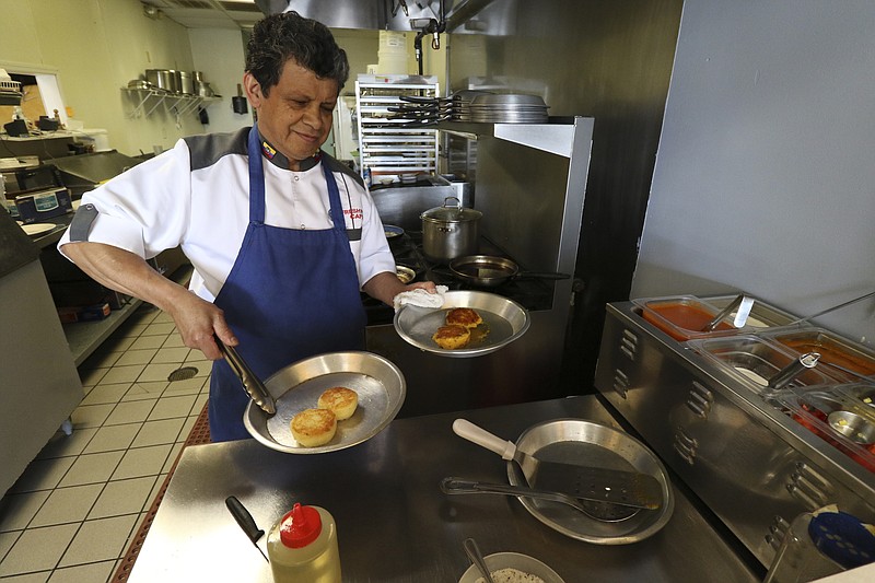 Owner and chef Marco F. Garrido prepares an Ecuadorian dish at Fresh Pot Cafe in Hixson.